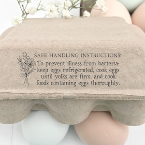 May include: A brown cardboard egg carton with a printed message: "SAFE HANDLING INSTRUCTIONS: To prevent illness from bacteria: keep eggs refrigerated, cook eggs until yolks are firm, and cook foods containing eggs thoroughly."