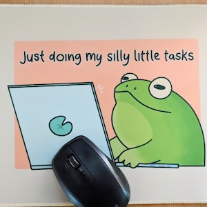 May include: A green frog sitting at a computer with the text "Just doing my silly little tasks".