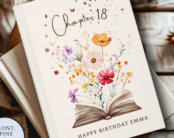 May include: A hardcover book with a cream-colored cover featuring the text Chapter 18 at the top and HAPPY BIRTHDAY EMMA at the bottom. The center displays a watercolor illustration of an open book with colorful wildflowers and butterflies.