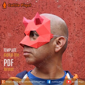 May include: A red geometric paper mask with horns, worn by a person. The mask is made of folded paper and has eye and nose openings. Text on the image reads "TEMPLATE digital file PDF format". The Etsy shop name "Caltia Piqui" is also visible.