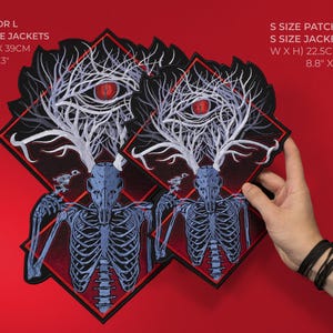 May include: Black and red embroidered patches with a skeletal deer design. The larger patch measures 11.6" x 15.3" (29.5cm x 39cm), and the smaller patch is 8.8" x 11.6" (22.5cm x 29.5cm). The patches feature a red eye and tree-like antlers.