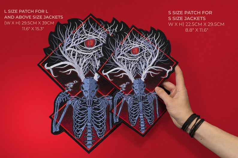 May include: Black and red embroidered patches with a skeletal deer design. The larger patch measures 11.6" x 15.3" (29.5cm x 39cm), and the smaller patch is 8.8" x 11.6" (22.5cm x 29.5cm). The patches feature a red eye and tree-like antlers.