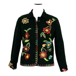 May include: Black jacket with colorful embroidered flowers and leaves. The jacket has a button closure and long sleeves.