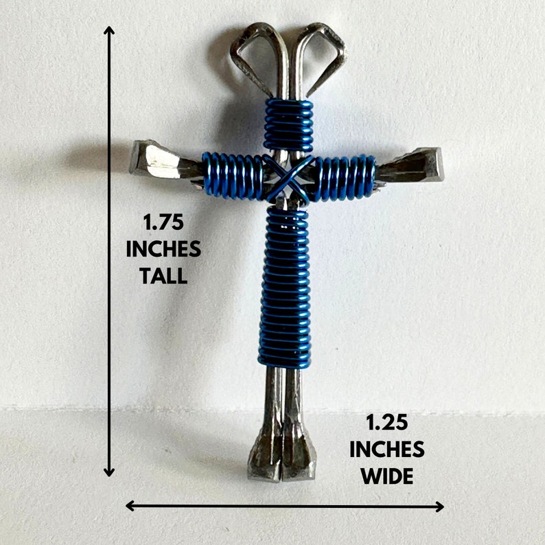 May include: A blue and silver metal cross made from horseshoe nails. The cross is 1.75 inches tall and 1.25 inches wide.