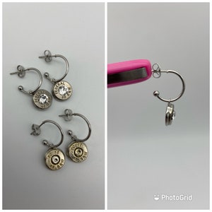 May include: Three pairs of silver hoop earrings with a bullet casing charm. Each charm has a small rhinestone in the center. The charms are engraved with the text "Federal 40 S&W".