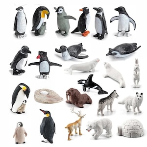 May include: A collection of plastic arctic animal figurines, including penguins, polar bears, seals, a walrus, a reindeer, a wolf, a fox, and an orca. There is also an igloo and a rock with a small egg on top.