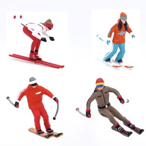 May include: Four miniature skier figurines in action poses. Each skier wears colourful ski attire, including red, orange, and brown outfits, with skis and poles. The figures are set against a white background, showcasing winter sports.