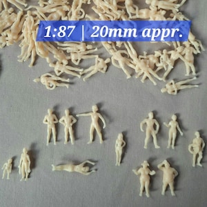 May include: A selection of small, unpainted plastic figures in different poses, including standing, reclining, and gesturing. The figures are a light beige colour. Text on a blue rectangle reads "1:87 | 20mm appr."