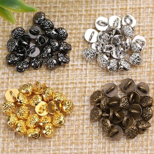 May include: Assortment of 20 small, round, textured buttons in four colors: black, silver, gold, and bronze. Each button has a small loop on the top for sewing.