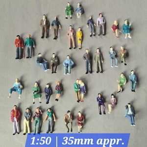 May include: Miniature figurines of people in various poses, dressed in colorful outfits. The figures are in a variety of poses, including standing, sitting, and embracing. The text "1:50 | 35mm appr." is visible at the bottom of the image.