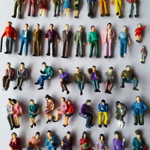 May include: A collection of miniature plastic figures of people in various poses and clothing. The figures are about 1 inch tall and are ideal for model railroading or other miniature scenes.