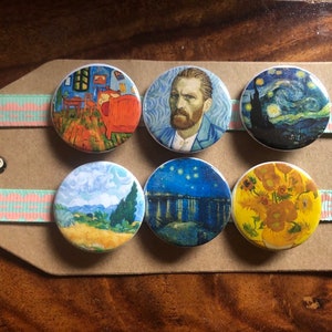 May include: Six round buttons featuring famous paintings by Vincent van Gogh. The buttons are white with a black border and feature images of "The Bedroom", "Self-Portrait", "Starry Night", "Wheatfield with Crows", "Starry Night Over the Rhone", and "Sunflowers".