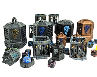 May include: A collection of 3D printed dice towers in various colours, including black, brown, and grey. The towers are shaped like cages with dragon designs. There are also several dice in the image, including a blue d6 with white numbers.