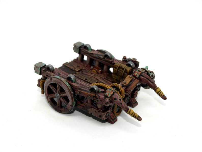 May include: A wooden miniature cart with two wheels, a rope, and two wooden arms. The cart is painted brown with green and gold accents.