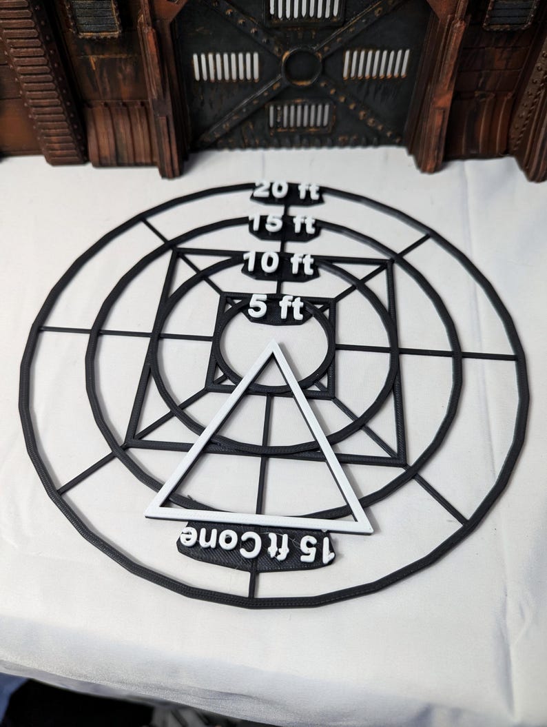 May include: A black and white target with concentric circles and a triangle in the center. The circles are labeled with distances in feet: 20 ft, 15 ft, 10 ft, and 5 ft. The triangle is labeled "15 ft cone".