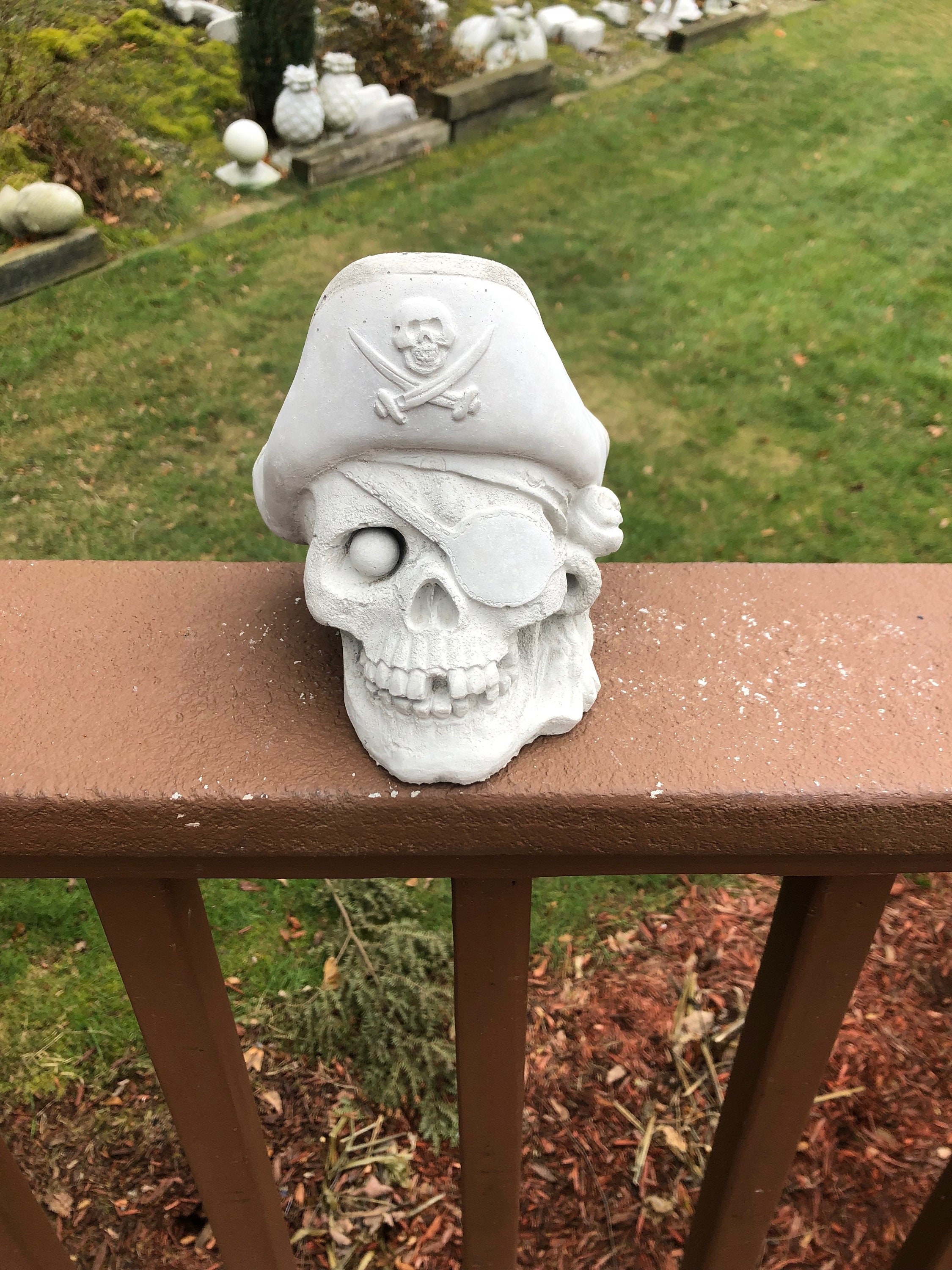 new Skull wearing a beanie hat.concrete garden ornament 