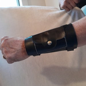 Leather forearm / wrist cuff, with pockets.  6&quot; wide 7 1/2&quot; long at the wrist diameter with three 3/4&quot; buckle bands.