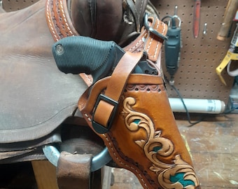 Saddle holster for auto-loader or revolver. Handmade for right handed use. Freehand engraved, monogrammed, and made from scratch.