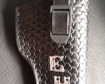 Pistol holster for auto-loader or revolver. Handmade for right handed use. Freehand engraved, monogrammed with heavy duty clip mount.