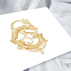 May include: A gold-colored, ornate, decorative letter S with intricate flourishes and swirls.
