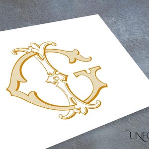 May include: A gold monogram with the letters "C" and "G" intertwined in a decorative, ornate style. The letters are surrounded by intricate flourishes and swirls.
