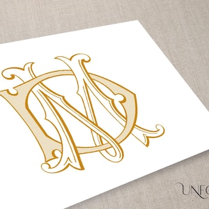 Könnte beinhalten: Ein goldenes Monogramm mit den Buchstaben "N" und "D", die in einer dekorativen, stilisierten Schriftart miteinander verschlungen sind.