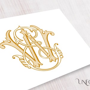 May include: A gold monogram featuring the letters "W" and "A" intertwined in a decorative, stylized font. The letters are surrounded by ornate flourishes.