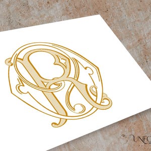 May include: A gold-colored monogram design featuring the letters "A" and "R" intertwined within an ornate, decorative frame. The design is set against a white background, with the words "UNFOLD MONOGRAMS" in the bottom right corner.