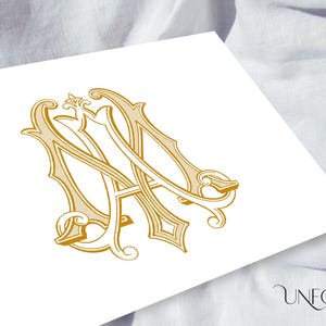 May include: A gold monogram with the letters "MA" intertwined in a decorative, ornate font.