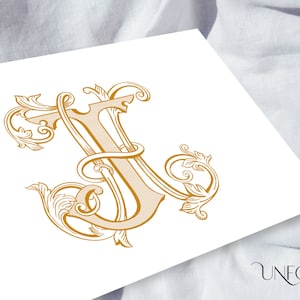 May include: A gold-colored, ornate, decorative letter J with intricate flourishes and swirls.