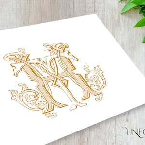 May include: A gold monogram with the letters "M" and "A" intertwined, surrounded by ornate flourishes.