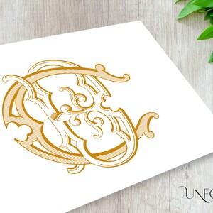 May include: A gold monogram design featuring the letters "C" and "V" intertwined in a decorative, ornate style.