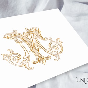 May include: A gold monogram with the letters "M" and "A" intertwined in a decorative, ornate, and intricate design. The letters are surrounded by stylized floral elements.
