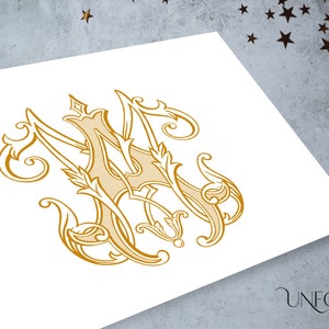 May include: A gold-colored monogram design featuring the intertwined letters "M" and "A" in an ornate, vintage style. The design includes decorative flourishes and leaf accents, set against a white background. The word "UNFOLD STUDIO" is printed in a script font.