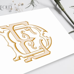May include: A gold monogram with the letters "FD" in a decorative, ornate font. The letters are intertwined and have a vintage, classic style.