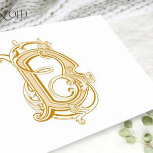 May include: A gold-colored, ornate, decorative letter B with intricate flourishes and swirls.