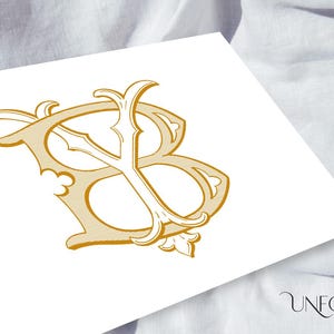 May include: A gold-colored monogram with the letters "B" and "Y" intertwined. The letters are in a decorative, stylized font with flourishes and swirls.