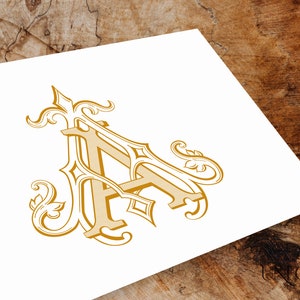 May include: A gold-colored, ornate, decorative letter A with intricate flourishes and swirls.