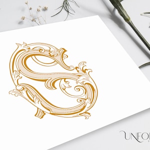 May include: A gold-colored, ornate, decorative letter S with a flourish design. The letter is on a white background.
