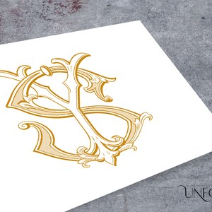May include: A gold monogram with the letters "S" and "Y" intertwined in a decorative, ornate style. The letters are surrounded by intricate flourishes and scrolls.
