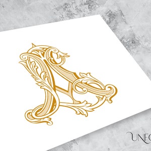 May include: A gold-colored, ornate, decorative letter A with intricate flourishes and swirls.
