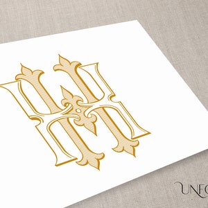 May include: A gold monogram with the letters "HH" in a decorative, ornate font. The letters are intertwined and have a vintage, classic style.