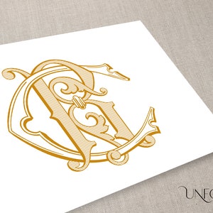 May include: A gold monogram with the letters "R" and "C" intertwined in a decorative, stylized font. The letters are surrounded by a circular frame with ornate flourishes.
