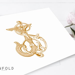 May include: An ornate, decorative letter S in gold, featuring intricate flourishes and swirls. The letter is set against a white background with the text "UNFOLD studio" in the bottom left corner.