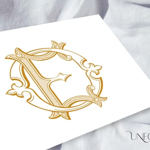 May include: A gold monogram initial "F" in a decorative, ornate, circular frame. The design is reminiscent of a vintage or antique style.