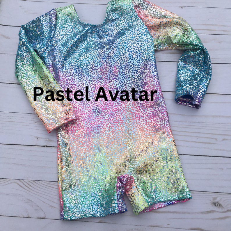 May include: A long-sleeved, iridescent leotard with a rainbow gradient pattern. The leotard has a textured, cracked-glass effect and the text "Pastel Avatar" is printed on the front.