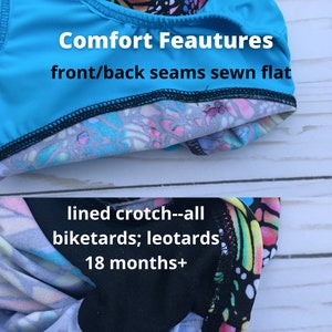 May include: Close-up of the inside of a blue and white patterned leotard or biketard. The seams are sewn flat for comfort. The text "Comfort Feautures front/back seams sewn flat lined crotch--all biketards; leotards 18 months+" is visible.