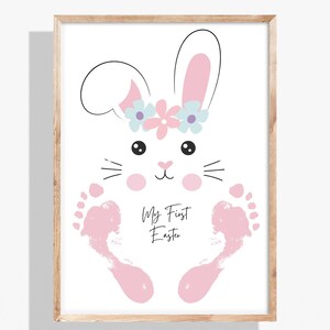 May include: A pink bunny rabbit with a flower crown made from handprints. The text "My First Easter" is written below the bunny.