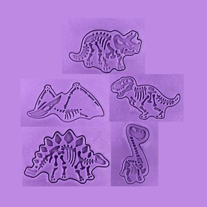 May include: Purple silicone mold with five dinosaur skeletons. The molds are for making cakes, cookies, or other treats.