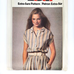 May include: A vintage Simplicity sewing pattern for a striped dress. The pattern number is 9020 and the price is £1.10. The pattern is for sizes 8, 10, and 12.